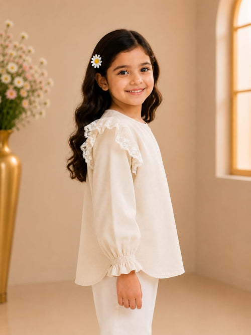 Side view of girl wearing Goodoo ivory lace ruffle top with long sleeves