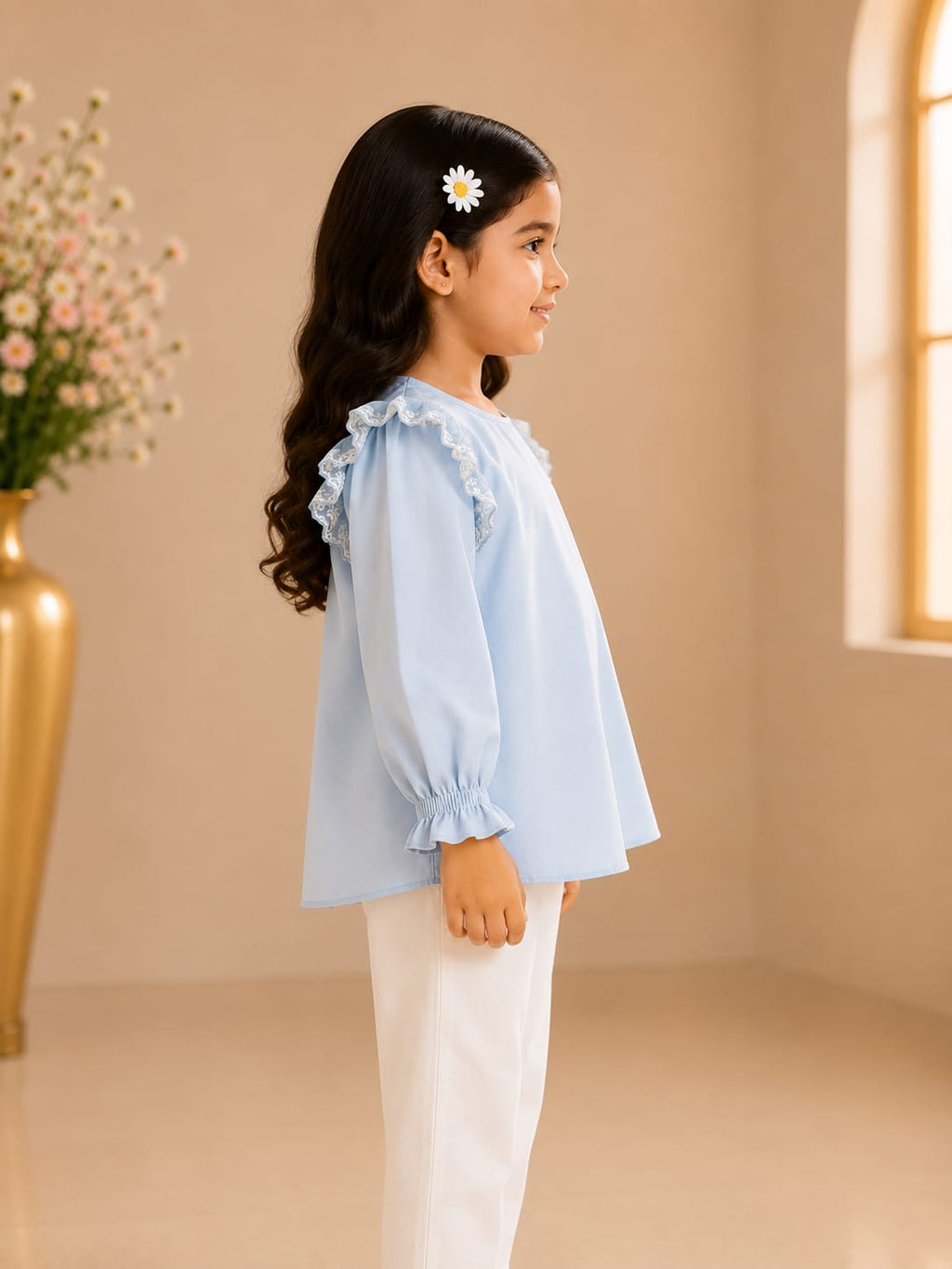 Side view of girl wearing Goodoo sky blue lace ruffle top with ruffle sleeves
